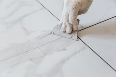Professional preparing grout for staining